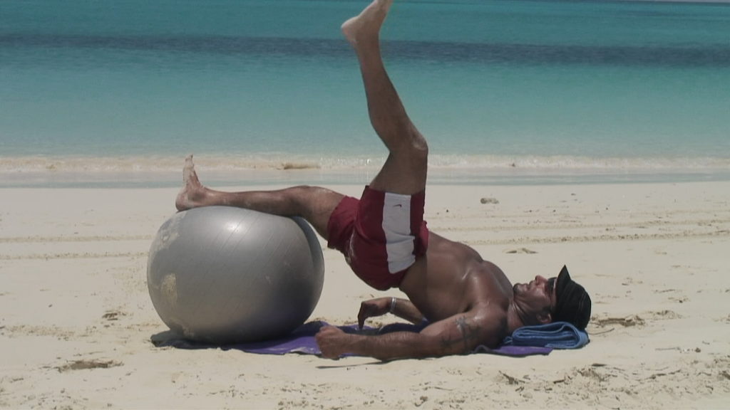 Christopher Mazzella performing a single leg lift on a exercise ball
